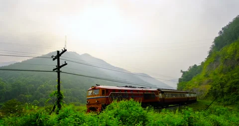 Rapid train pass through the scenic landscape along the hillside Stock Footage 202238308