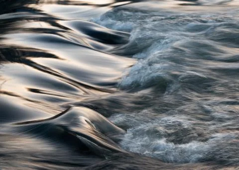 Rapid water flows in stream making cascades Stock Photos