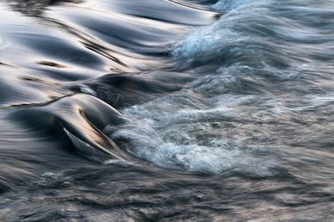 Rapid water flows in stream making cascades Stock Photos