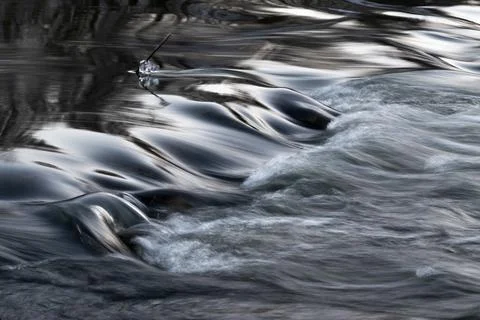 Rapid water flows in stream making cascades Stock Photos