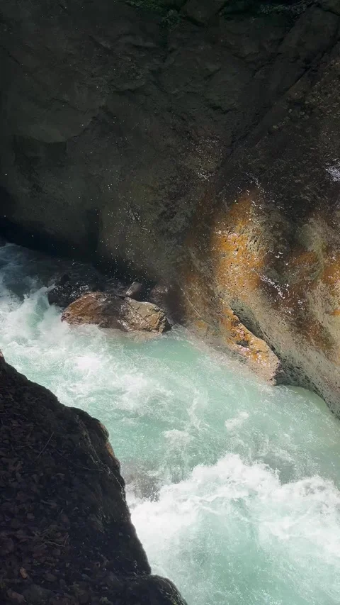 Rapid Water Flows Through Rocky Canyon in Scenic Natural Landscape During Bright Stock Footage 314393613