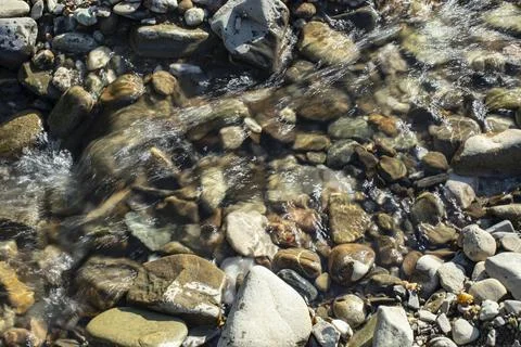 Rapid water stream river close up stones with sunlight  and motion blur Stock Photos