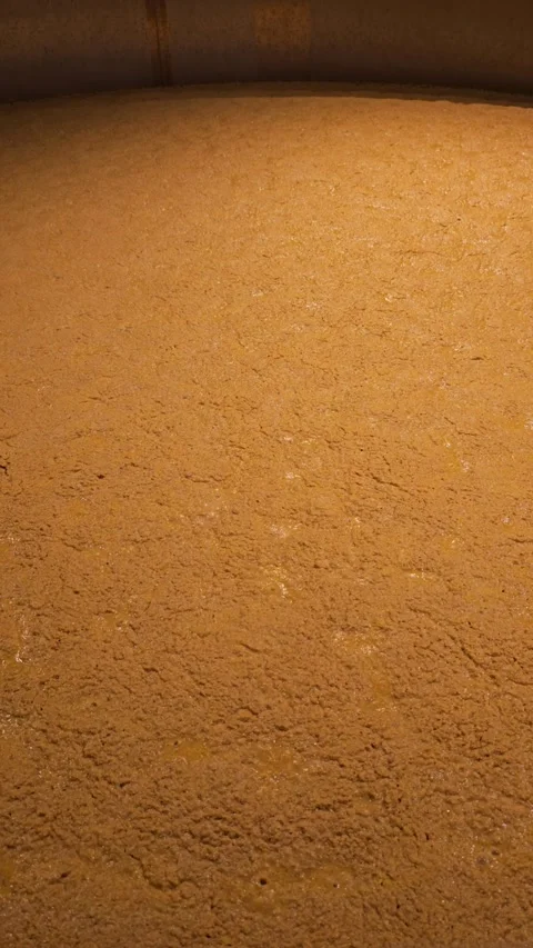 Rapidly bubbling fermentation vat for bourbon or beer production vertical video Stock Footage 325674808