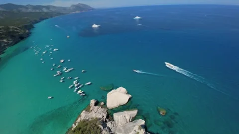 Rapidly descending and rotating left, an FPV drone sweeps above anchored boats Stock Footage 342282181