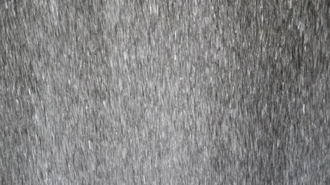 The rapidly falling water forms a wall of water droplets, solid background. Video stock 131126656