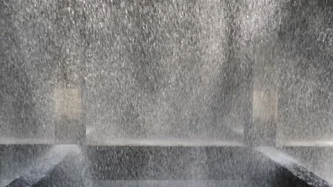 The rapidly falling water forms a wall of water droplets, solid background. 動画素材 131126737