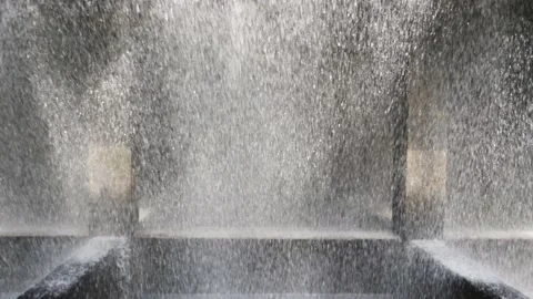The rapidly falling water forms a wall of water droplets, solid background. Video stock 131126858