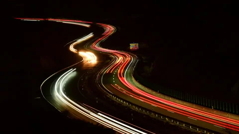 Rapidly moving rush hour traffic travels over the Highway at dusk. Stock Footage 167855521