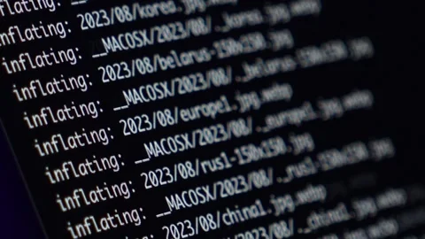 Rapidly scrolling lines of code on a dark screen, emphasizing real-time progr Stock Footage 295380859