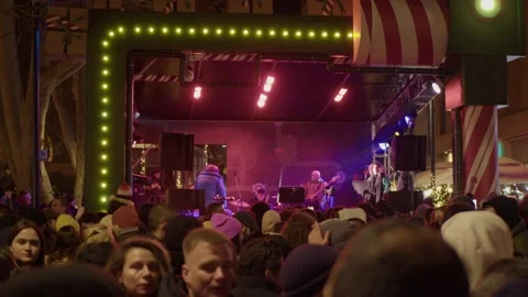 Rapper performs on stage with songs, passers-by enjoy music and dance Stock Footage 228756909