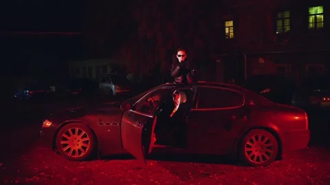 Rapper reads rap from the hatch of the car, lipsing the rapper Stock Footage 229795449