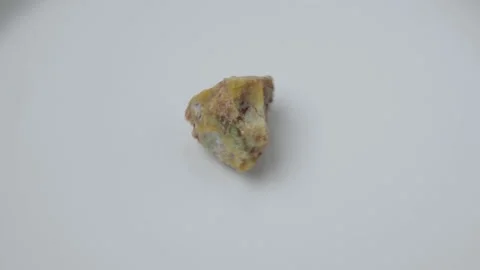Rare boulder opal, mineral, white background. Opal is a hydrated amorphous form Stock Footage 233527864