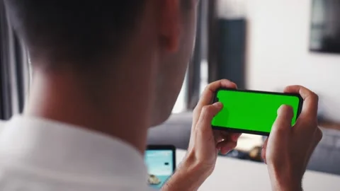 Rare Close-up of the unrecognizable Man Holding Green Screen Smartphone in Stock Footage 138904346