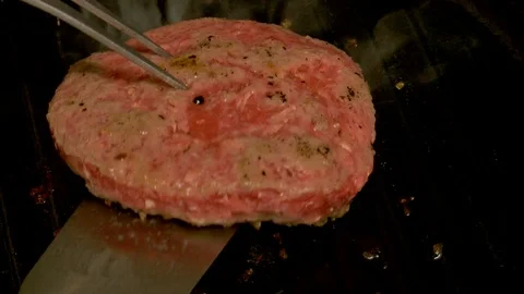 Rare hamburger flipped over while cooking on cast iron griddle Stock Footage 119512850