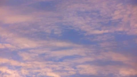 Rare pink clouds float in the blue sky. Time laps. Stock Footage 142078832