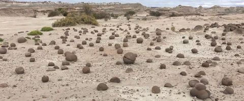 Rare round eroded rock formations on the ground in the desert Video stock 90661979