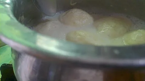 Ras malai balls being prepared in a traditional silver pot Stock Footage 318663628