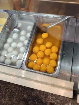 Rasgullas and Sweets in a container Stock Photos