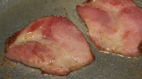 Rashers of bacon being fried in a pan Stock Footage 44350843