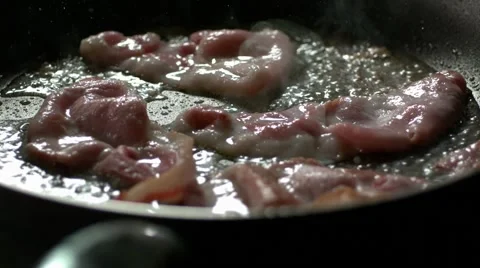 Rashers of bacon frying in a pan. Slow Motion. Stock Footage 41203442