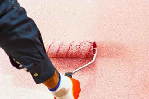 Rasit hand wall paint using a paint roller while working indoors Stock Photos