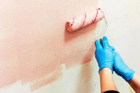 Rasit hand wall paint using a paint roller while working indoors Stock Photos