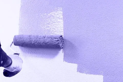 Rasit hand wall paint using a paint roller while working indoors Stock Photos