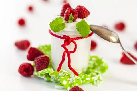 Raspberries and yoghurt or clotted cream Stock Photos