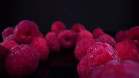 Raspberries on a black background Close up, view Stock Footage