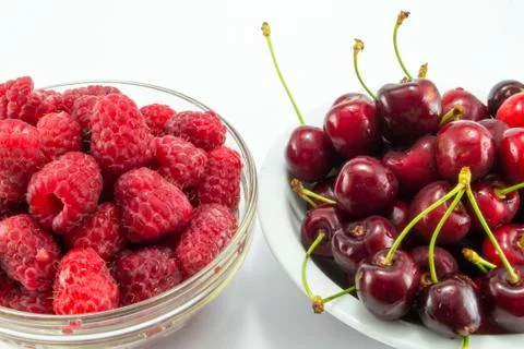 Raspberries with cherries Stock Photos