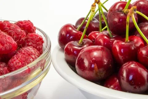 Raspberries with cherries Stock Photos