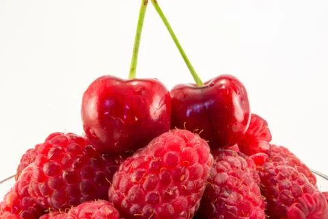 Raspberries with cherries Stock Photos
