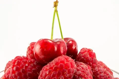 Raspberries with cherries Stock Photos