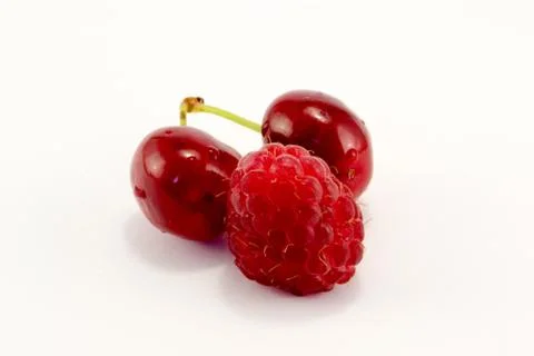 Raspberries with cherries Stock Photos