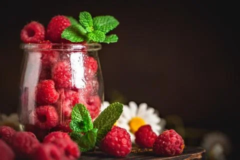 Raspberries in a Cup on a dark background. Summer and healthy food concept. B Stock Photos