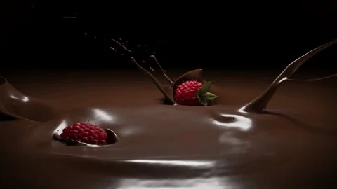 Raspberries falling into melt chocolate Stock Footage 83731174
