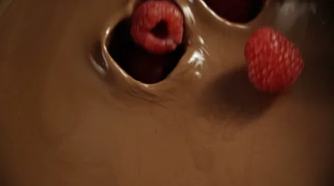 Raspberries Falling into Melted Chocolate Stock Footage 66734635