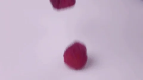 Raspberries falling into milk in slow motion. Raspberry falls into Yogurt in Stock Footage 79050704