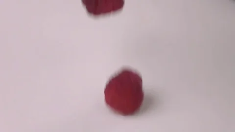 Raspberries falling into milk in slow motion. Raspberry falls into Yogurt in Stock Footage 79050714