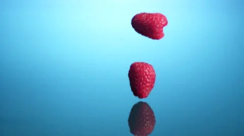 Raspberries falling into water Stock Footage 8572459