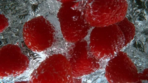 Raspberries falling into water Stock Footage 170392551