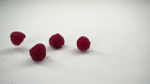 Raspberries Falling on a White Surface in Slow Motion. Stock Footage 61643183