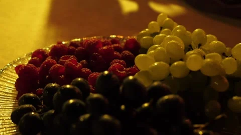 Raspberries grapes plate Stock Footage 245717181