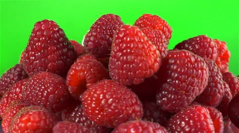 Raspberries isolated rotating on green background Stock Footage 62392886