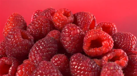 Raspberries isolated rotating on red background Stock Footage 62393485