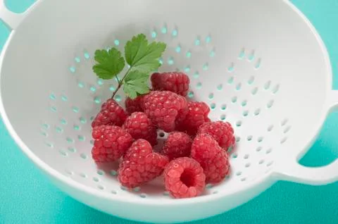 Raspberries with leaf in colander Stock Photos