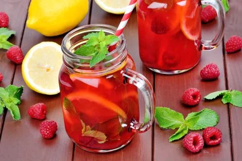 Raspberries lemonade in a jars on table Stock Photos