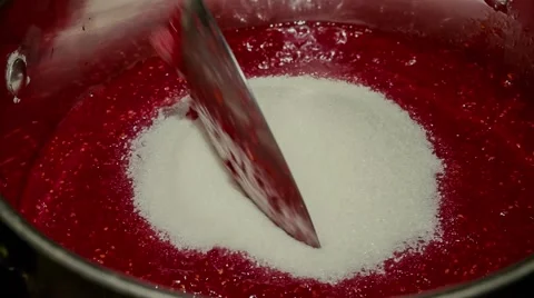 Raspberries mashed in a pan with the sugar Stock Footage 63321596