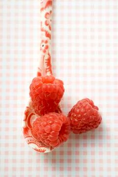Raspberries on patterned spoon 스톡 사진