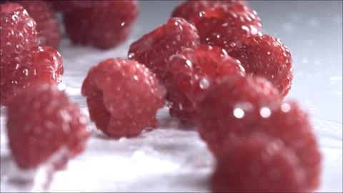 Raspberries Rolling Down on White Background. Slow Motion Stock Footage 156325489